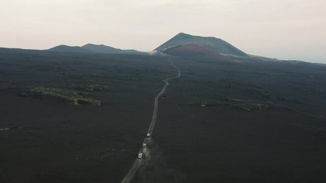 Aerial view of black desert landscape at Kamchatka, Russia. Volcanic landscape. Volcano in the background.