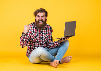 successful handsome bearded guy with unshaven face and stylish hairdo wear casual clothes working...