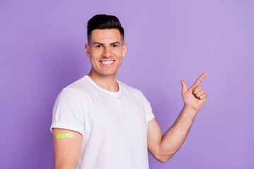 Profile side photo of young man point finger empty space ad advise vaccination plaster isolated over violet color background