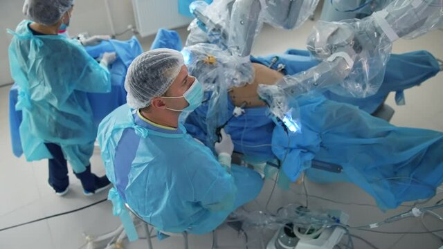 Surgeons in masks working in hospital. Professional medical equipment for surgery treatment.
