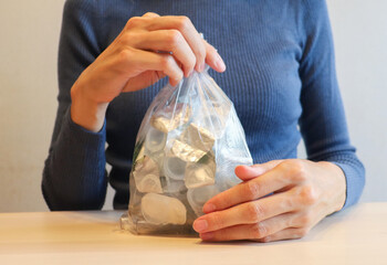 open, used plastic containers for contact lenses in a plastic bag, in the hands of a woman, in an...