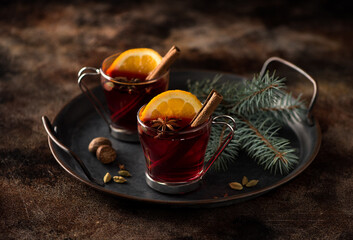 Christmas mulled wine with spices in glass cups. Festive background