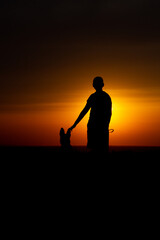 Fototapeta na wymiar man with dog at sunset