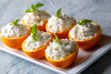 Celery salad with apple and walnuts served in orange cups.