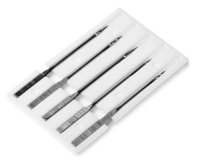 Set of sewing machine needles with package isolated on white