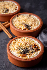 Baked rice pudding turkish milky dessert sutlac in earthenware casserole with hazelnuts