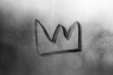 crown isolated on gray misted glass background. Emperor treasure. Close up covid symbol