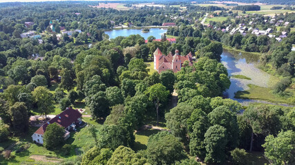 Aerial View of Edole Village, Edole Medieval Castle and Lake in Sunny Summer, Latvia, Courland (Kurzeme), Western Latvia. History, Architecture, Travel Destinations, National Landmark
