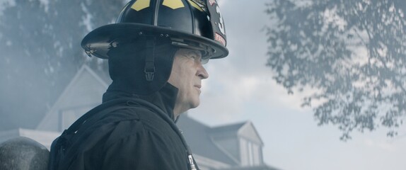 Portrait of firefighter chief standing hear fire site in the neighborhood