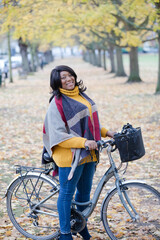 Portrait smiling, confident senior woman bike riding in autumn park