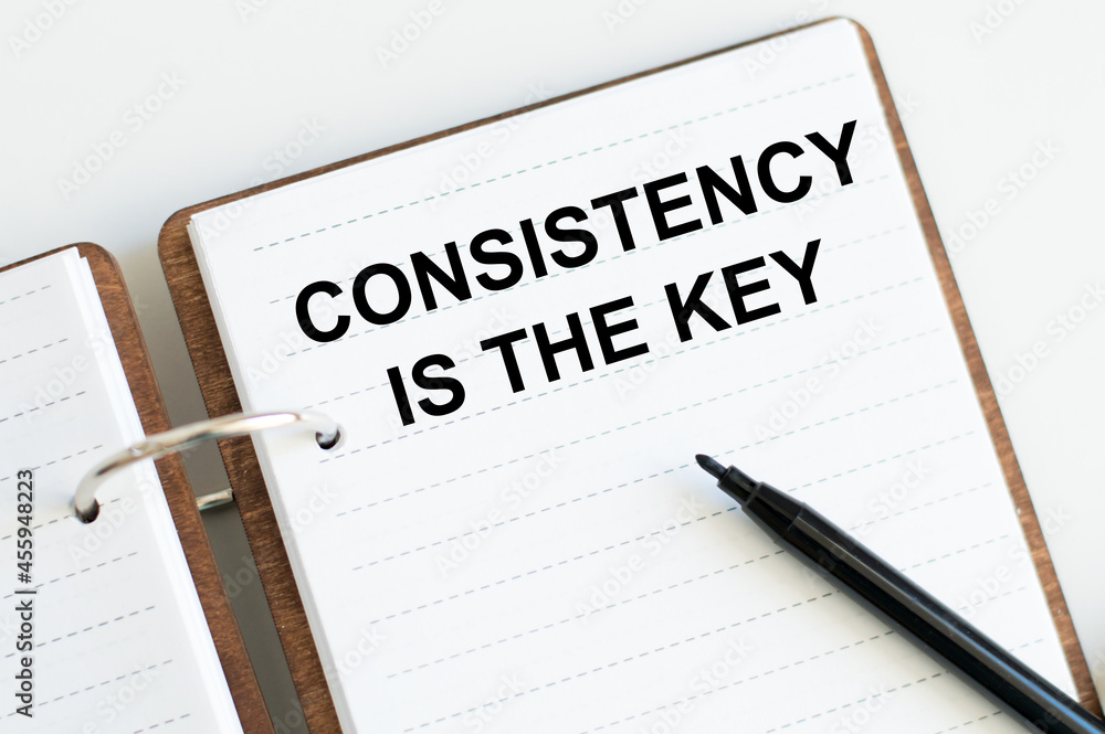 Poster consistency is key text on a notebook on a white background