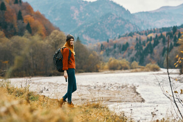woman with backpack mountain river travel lifestyle freedom