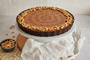 Delicious and nicely decorated peanut butter cheesecake on a stand