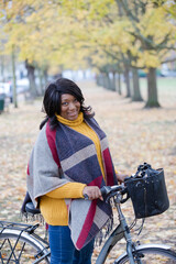 Obraz premium Portrait smiling, confident senior woman bike riding in autumn park