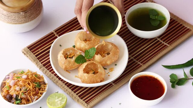 Girl women eating serving Pani puri golgappe with hand Chat item India. North Indian street food Indian panipuri snack 4K footage video tamarind water potato stuffing Delhi Mumbai Holi Diwali Dussehra