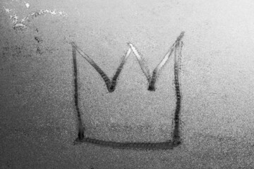 crown isolated on gray misted glass background. Emperor treasure. Close up covid symbol