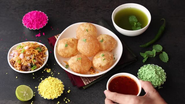 Girl women eating serving Pani puri golgappe with hand Chat item India. North Indian street food Indian panipuri snack 4K footage video tamarind water potato stuffing Delhi Mumbai Holi Diwali Dussehra