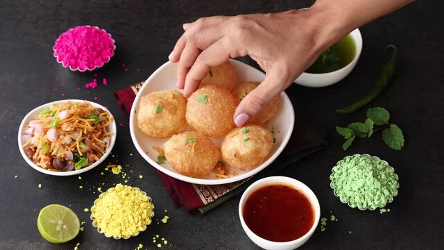 Girl women eating serving Pani puri golgappe with hand Chat item India. North Indian street food Indian panipuri snack 4K footage video tamarind water potato stuffing Delhi Mumbai Holi Diwali Dussehra