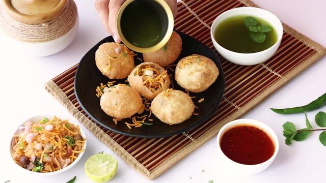 Girl women eating serving Pani puri golgappe with hand Chat item India. North Indian street food Indian panipuri snack 4K footage video tamarind water potato stuffing Delhi Mumbai Holi Diwali Dussehra
