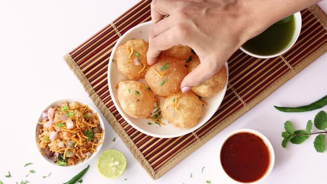 Girl women eating serving Pani puri golgappe with hand Chat item India. North Indian street food Indian panipuri snack 4K footage video tamarind water potato stuffing Delhi Mumbai Holi Diwali Dussehra