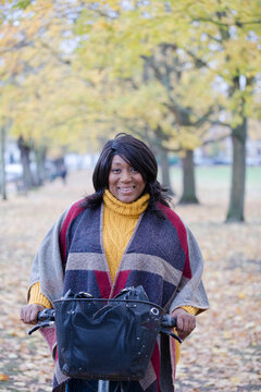 Portrait smiling, confident senior woman bike riding in autumn park