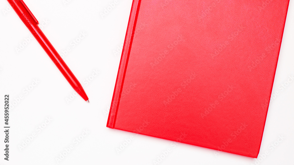 Aufkleber on a white background, a red pen and a red notebook with a place to insert text. template
