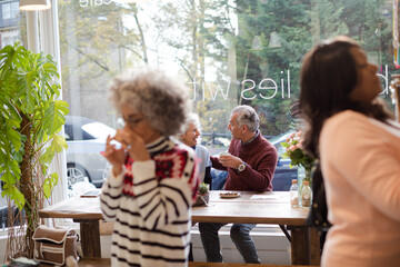 Smiling active senior couple enjoying coffee at  cafe