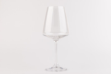 Empty transparent wine glass on the white background