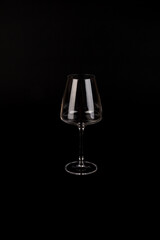 Empty transparent wine glass on the black background