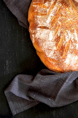 Freshly baked homemade bread on a black background