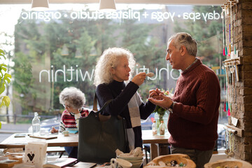 Senior couple talking and shopping at store
