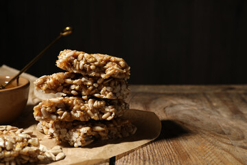 Delicious sweet kozinaki pieces on wooden table. Space for text