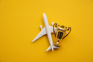 Airplane travel awards. Aviation business satisfaction. Toy airplane with gold trophy