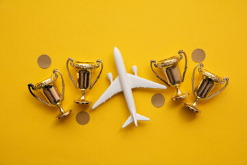 Airplane travel awards. Aviation business satisfaction. Toy airplane with gold trophy