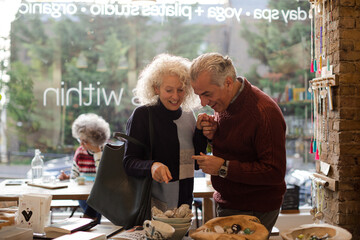 Senior couple talking and shopping at store