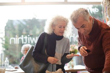 Senior couple talking and shopping at store