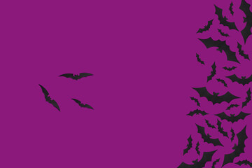 Halloween flat lay composition of black paper bats fly up on purple background, top view. Banner, copy space..