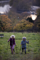 Portrait smiling, happy active senior women friends with walking sticks