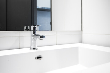 Bathroom interior with sink and faucet.