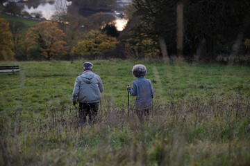 Affectionate senior couple with walking sticks