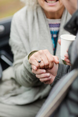 Affectionate senior couple holding hands in car