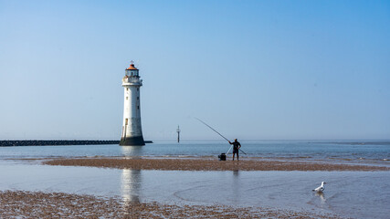 An angler at the low tide of the Irish Sea
