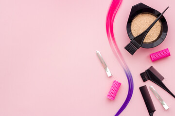 Obraz na płótnie Canvas Strand of coloring hair with hair dye bowl with brush hair salon tools