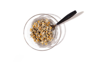top view of plate of cockles with fork as a snak and white background with copy space
