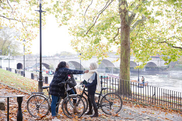 Fototapeta premium Portrait confident, smiling senior women bike riding in autumn park