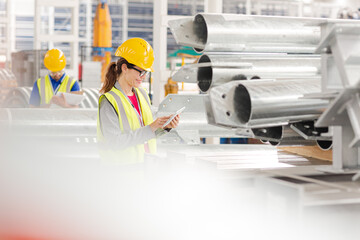 Workers with digital tablet working in factory