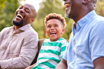 Smiling Multi-Generation Male Family At Home In Garden Together