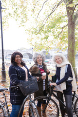 Portrait confident, smiling senior women bike riding in autumn park