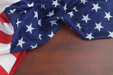 USA flag on wooden background. Close up of waved United States flag wit copy space for text.	