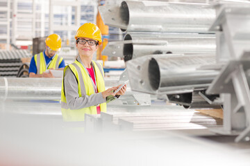 Workers with digital tablet working in factory